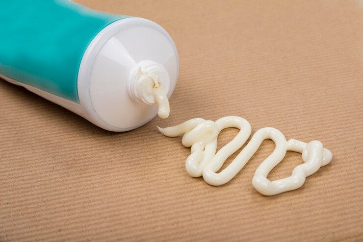 pharmaceutical medicine healing topical application ointment concept with plastic tube pushing white cream 1048944 16453560